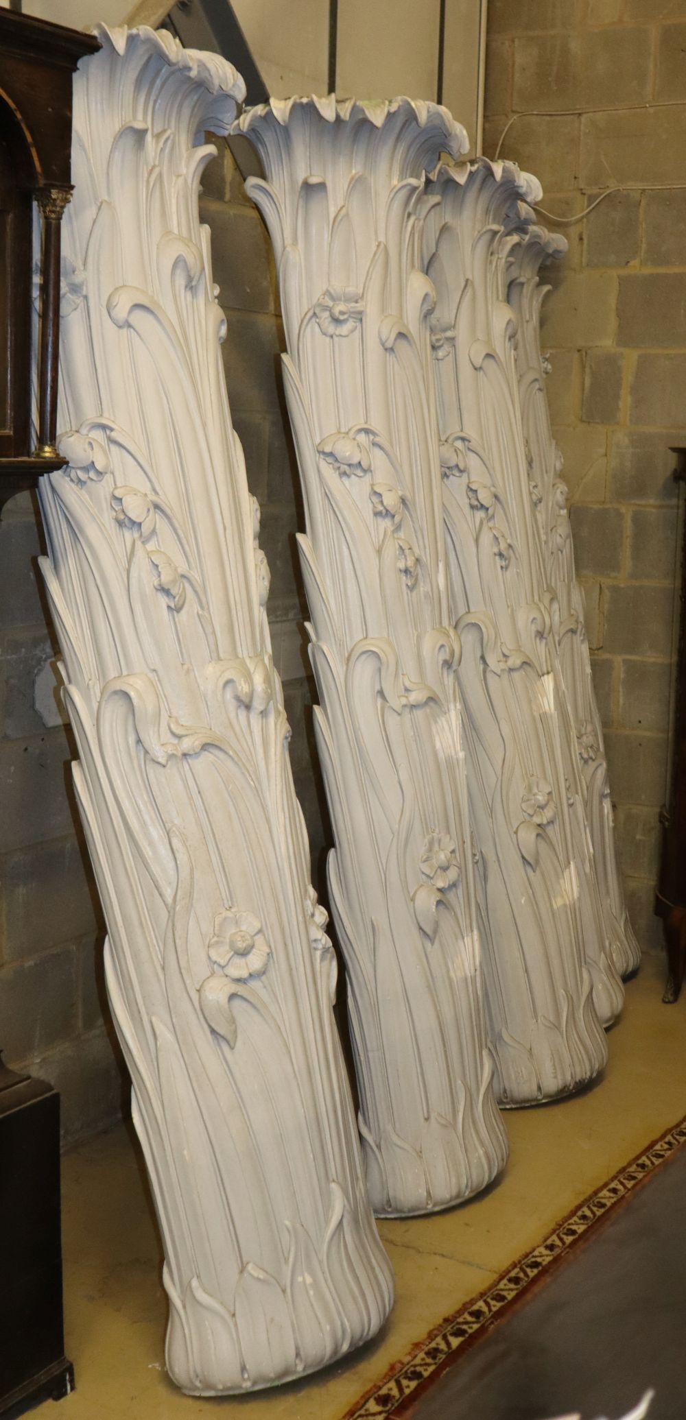 Five painted wood and plaster, acanthus scroll and floral columns, larger W64cm, H.30cm, H.214cm